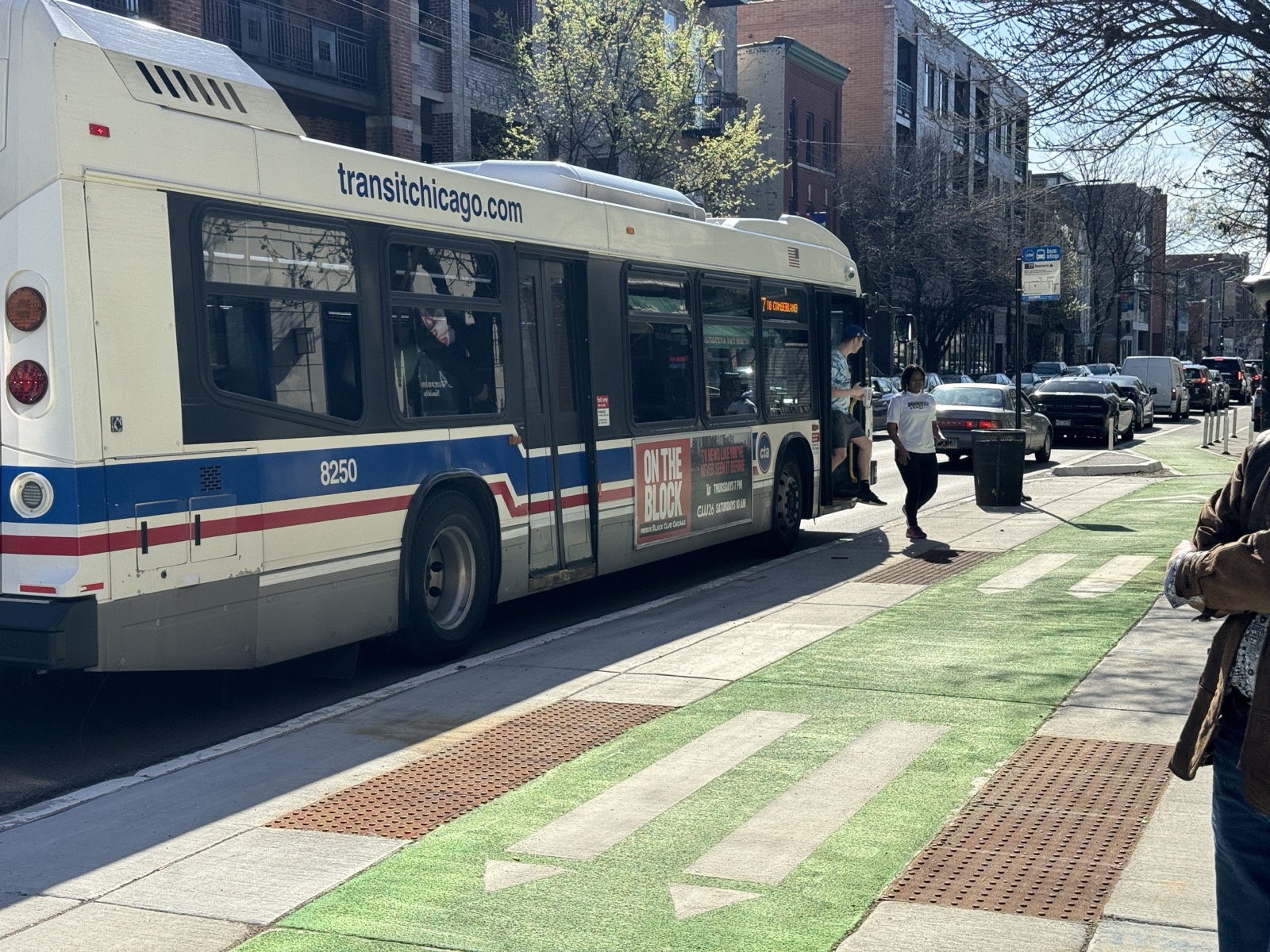 CTA bus at a boarding island next to a protected bike lane
