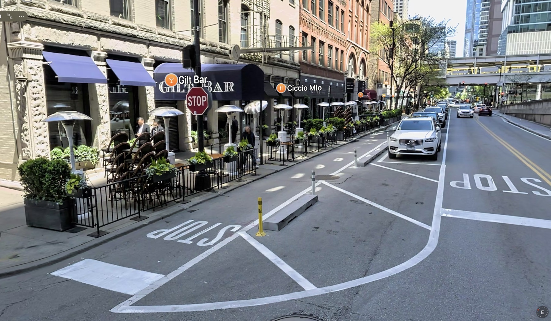 Protected bike lane and curbside dining area at 230 W Kinzie