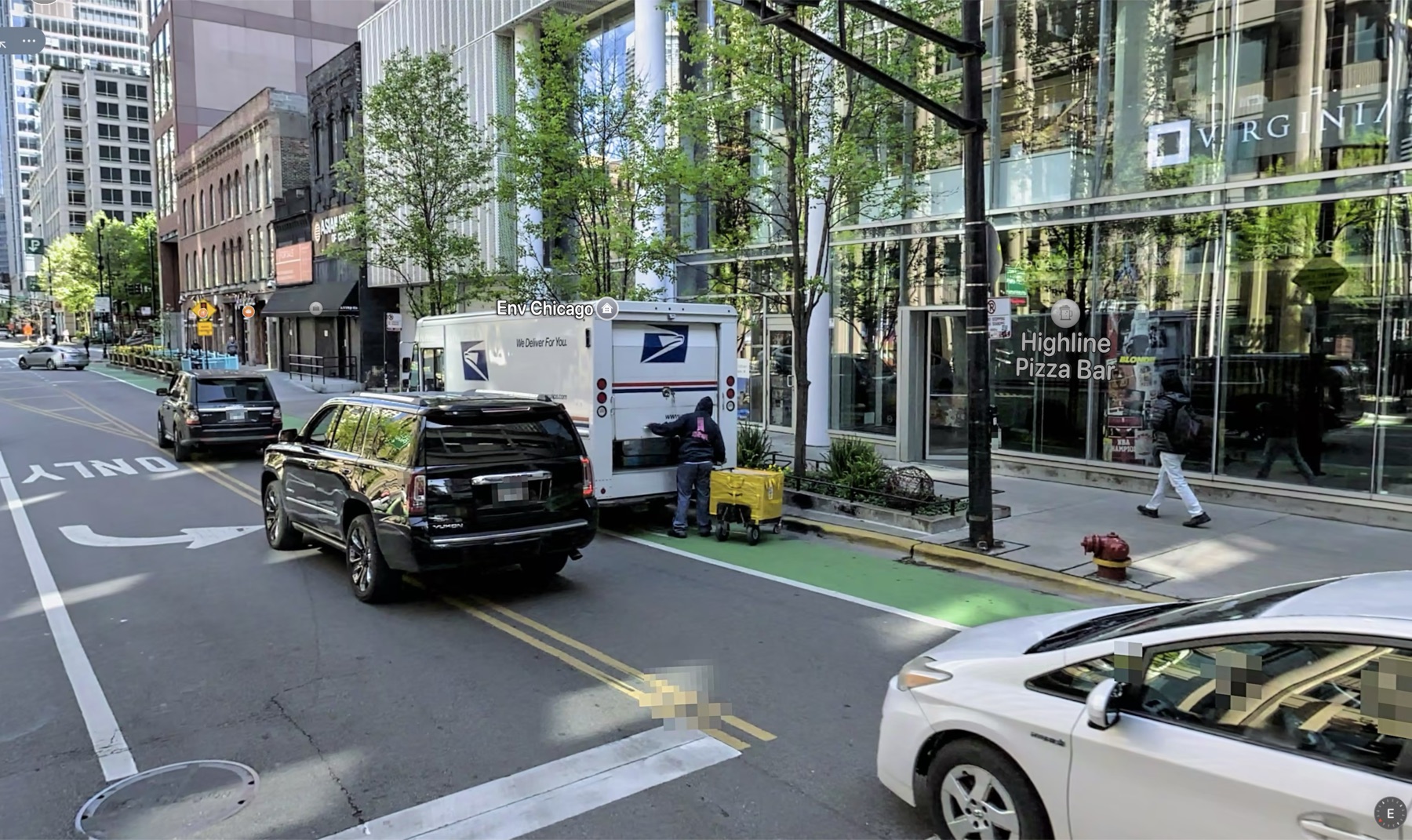 Paint-only bike lane blocked by standing vehicles at 169 W Kinzie